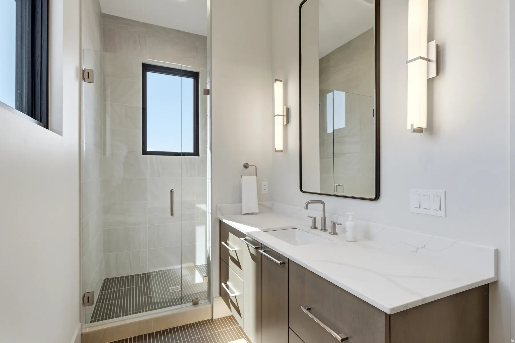 Full bathroom with vanity and a stall shower