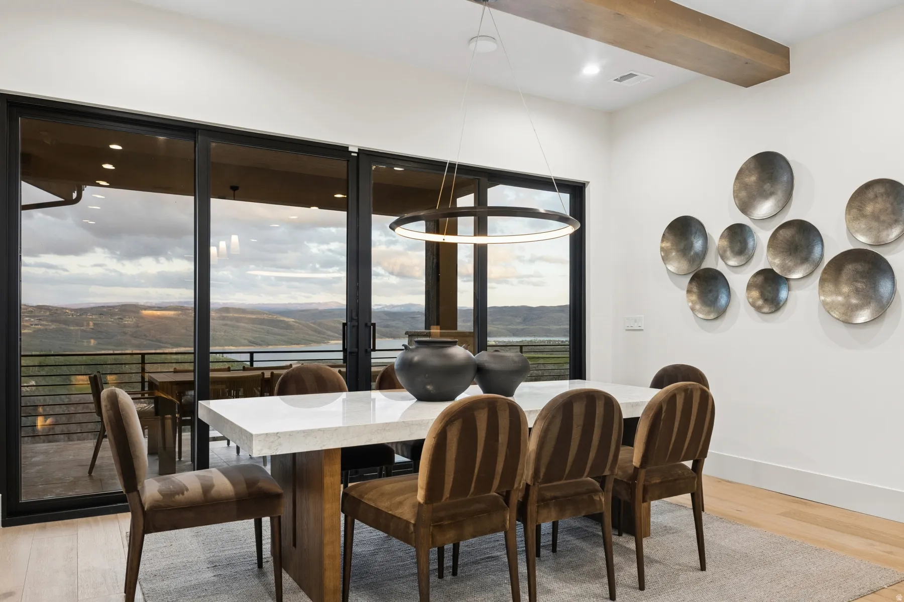 Dining room featuring a mountain view, light wood-style flooring, beamed ceiling, and recessed lighting