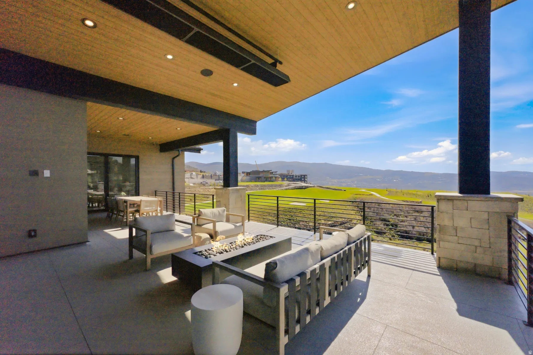 View of patio featuring an outdoor living space with a fire pit and a mountain view