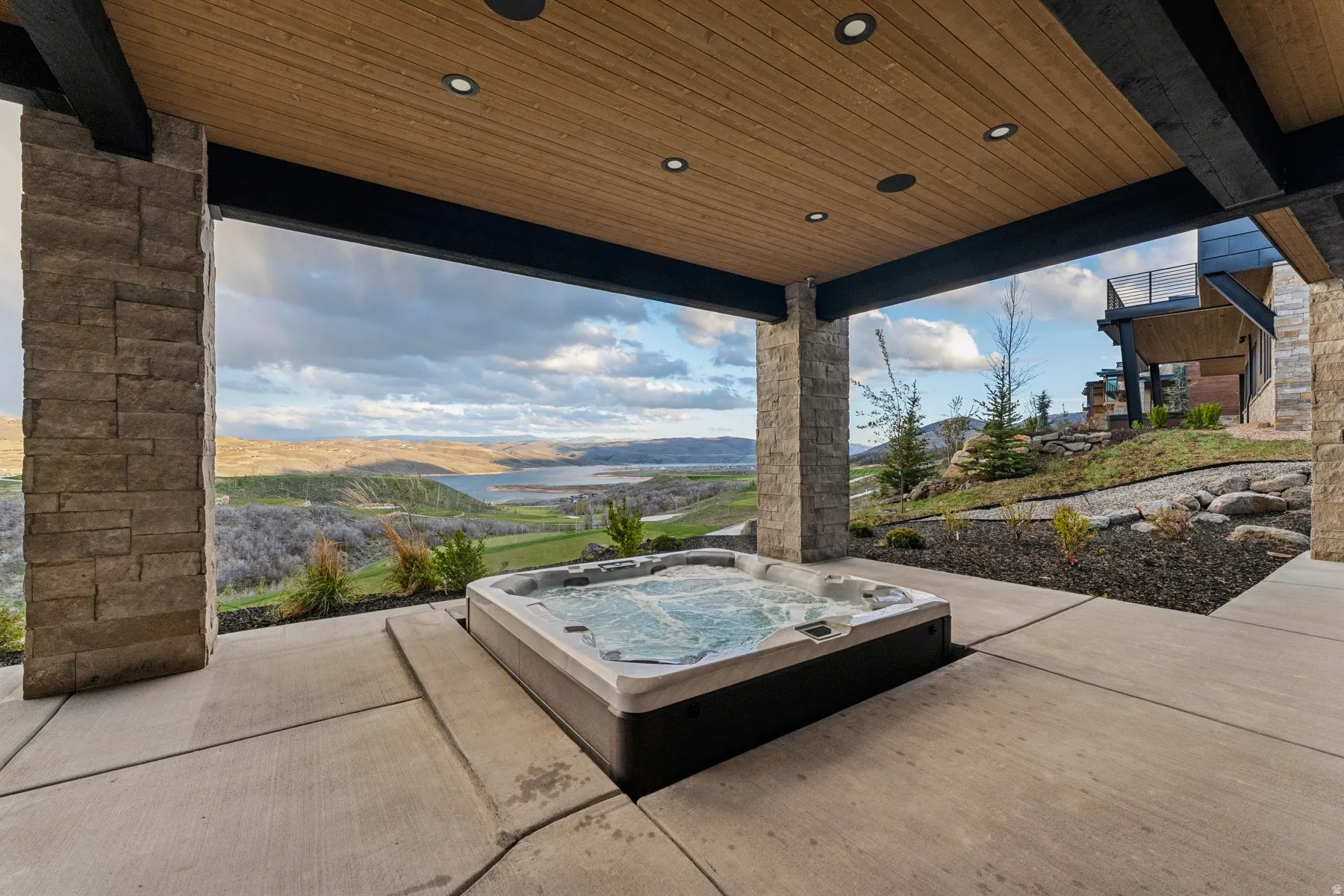 View of patio featuring a hot tub and a mountain view