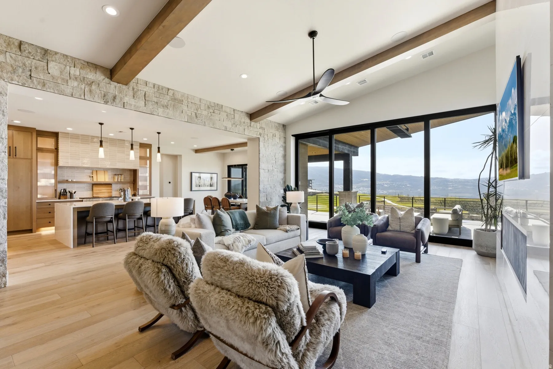 Living area with beam ceiling, light wood-style flooring, ceiling fan, recessed lighting, and a mountain view
