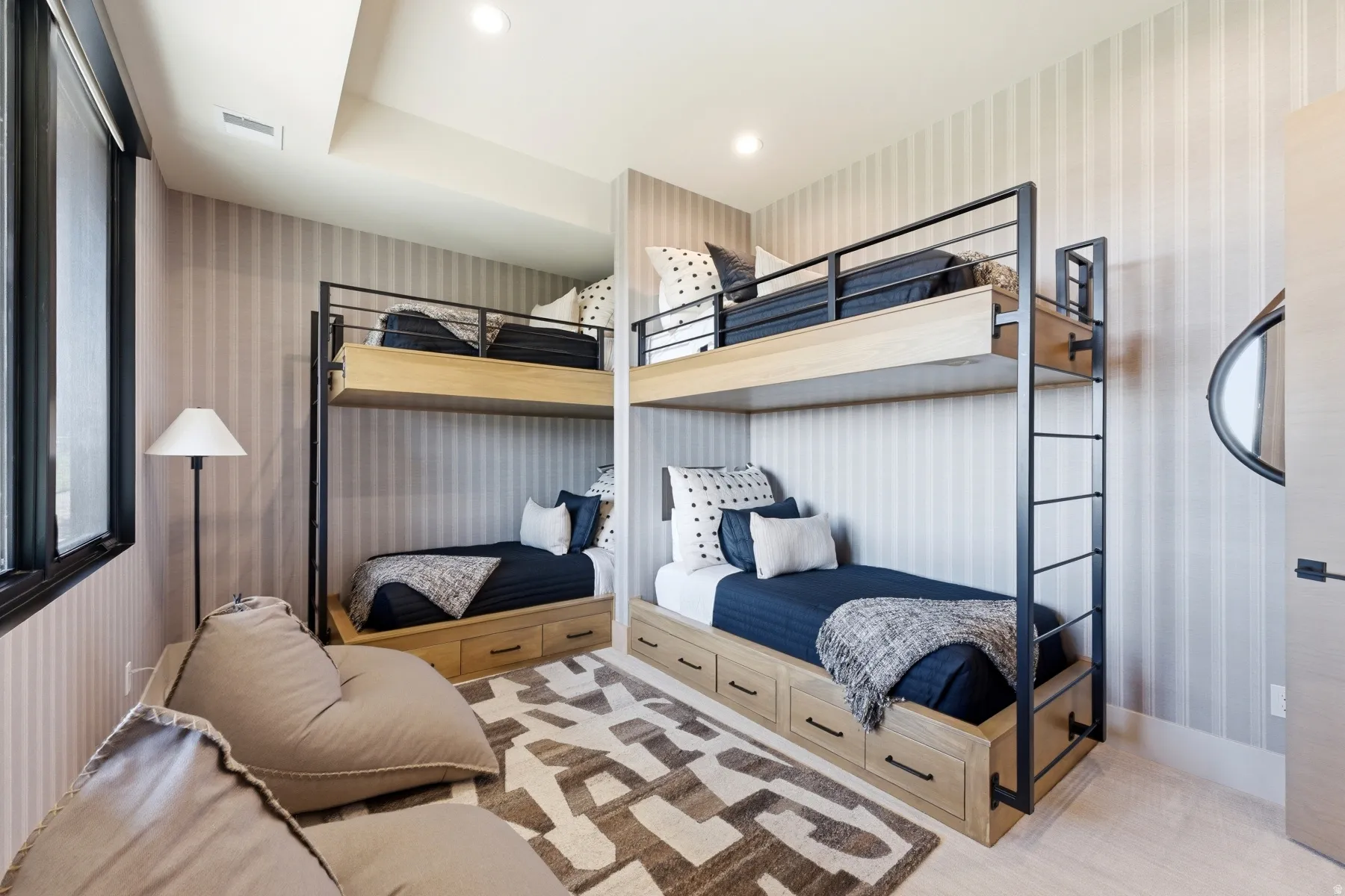 Bedroom with wallpapered walls and recessed lighting