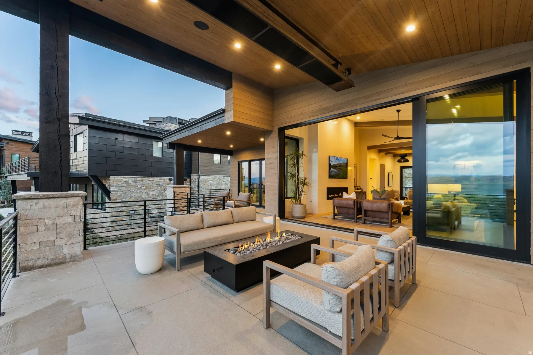 View of patio featuring an outdoor living space with a fire pit