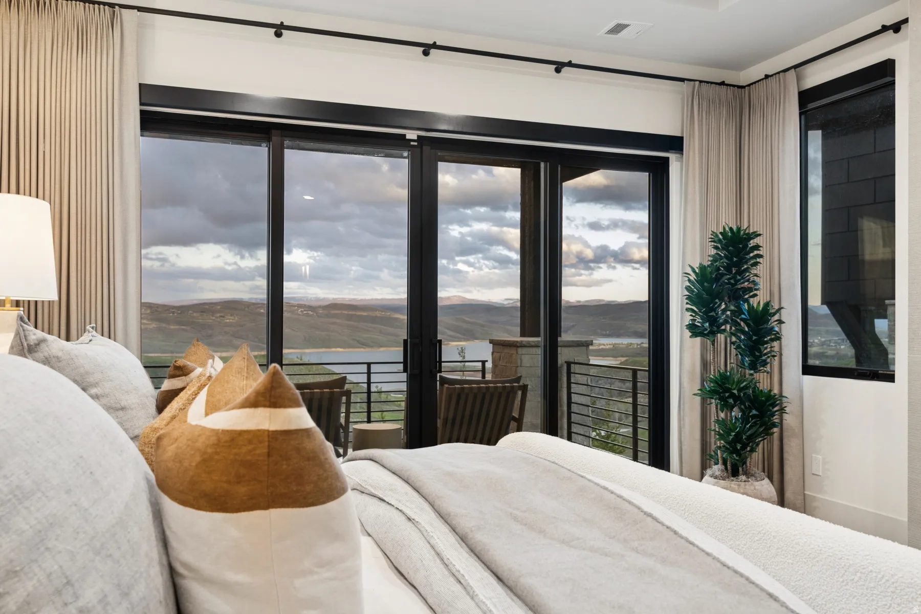 Bedroom featuring a mountain view, access to exterior, and multiple windows