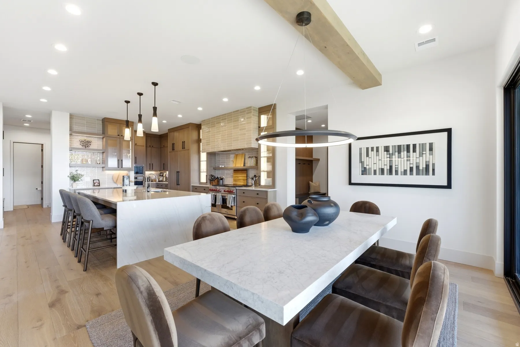 Dining space featuring light wood finished floors, recessed lighting, and beam ceiling