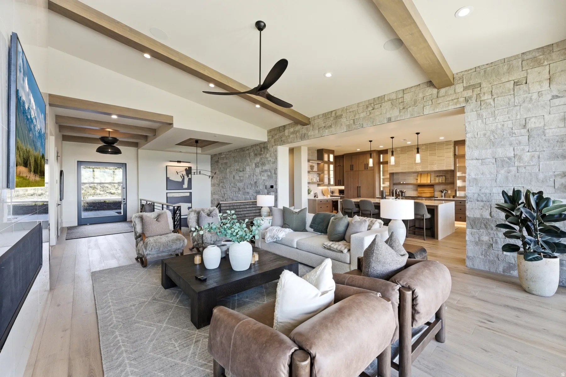 Living area with beam ceiling, a ceiling fan, recessed lighting, and light wood-style floors