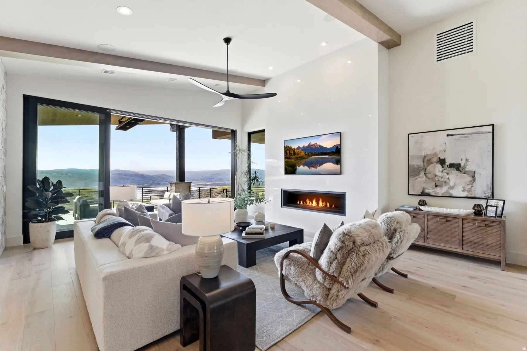 Living area featuring a lit fireplace, light wood finished floors, and recessed lighting