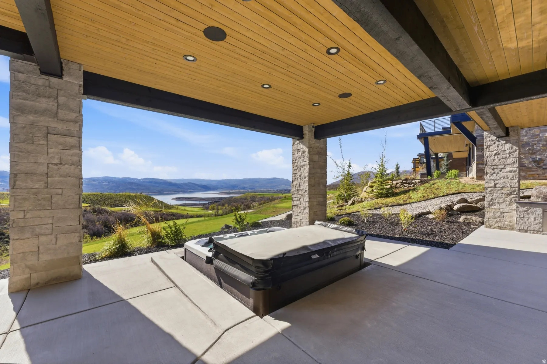 View of patio / terrace featuring a mountain view and a hot tub