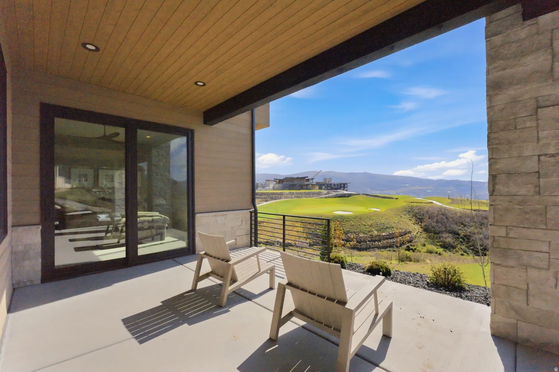 View of patio with a mountain view and golf course view