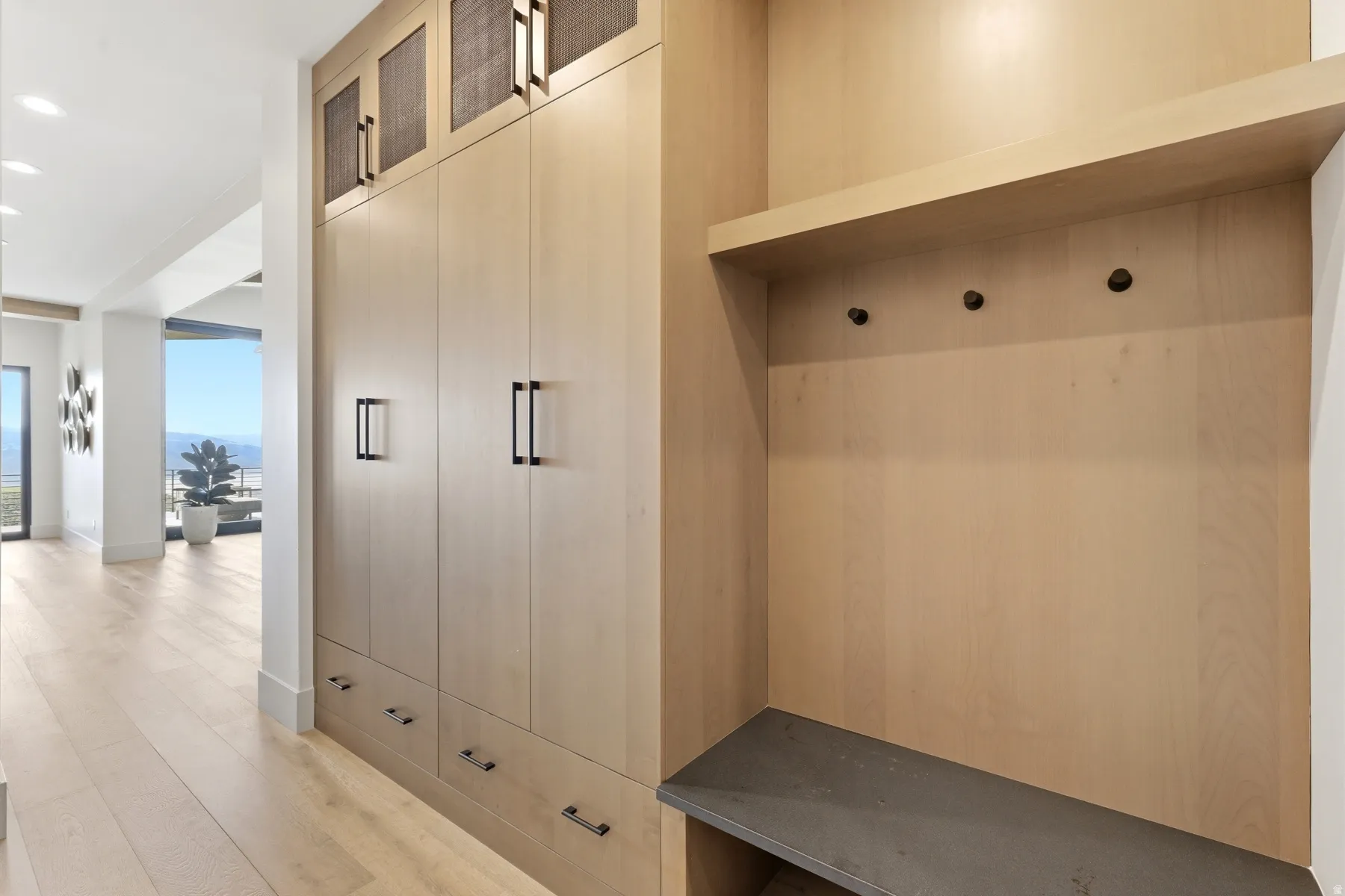 Mudroom featuring light wood finished floors and recessed lighting