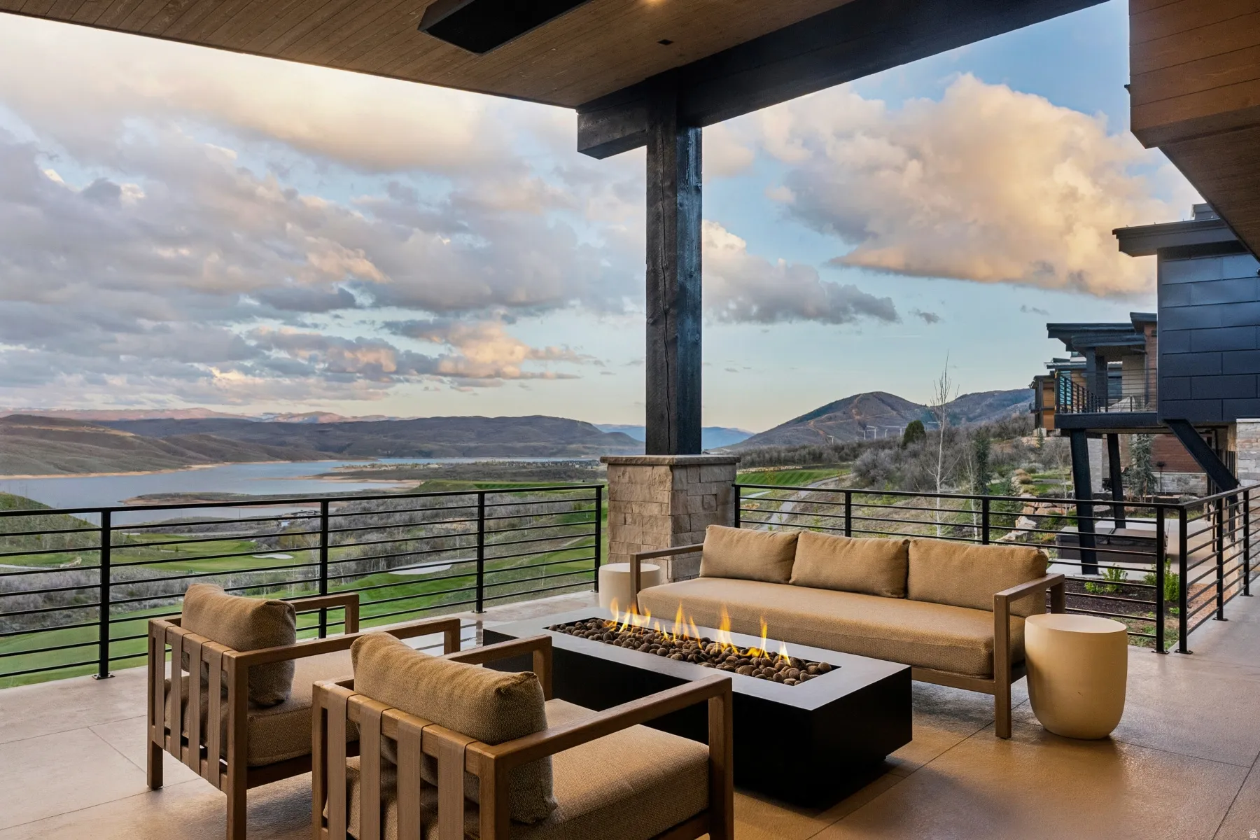 View of patio with a mountain view and an outdoor living space with a fire pit