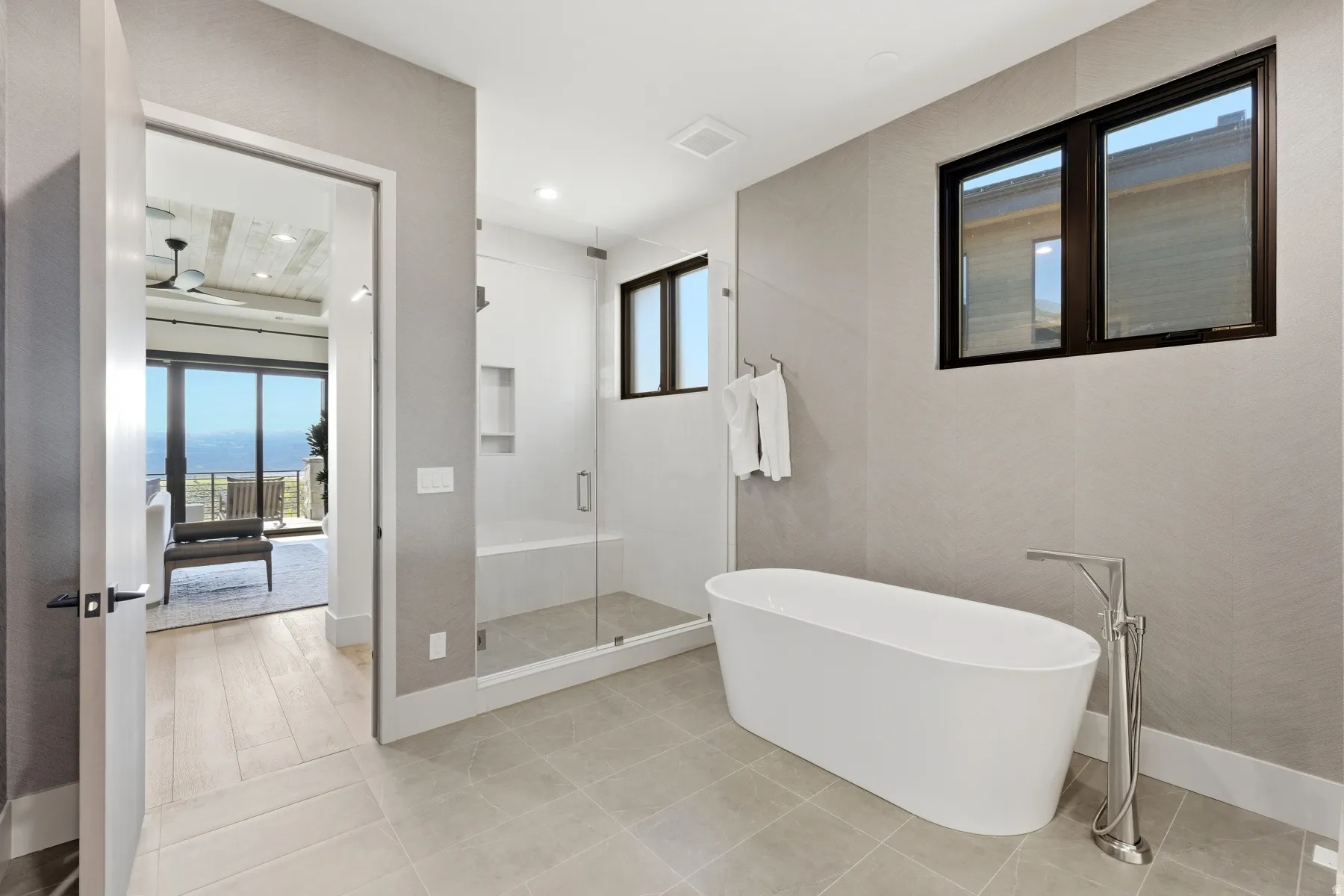 Bathroom featuring a stall shower, a freestanding tub, light tile patterned floors, and recessed lighting