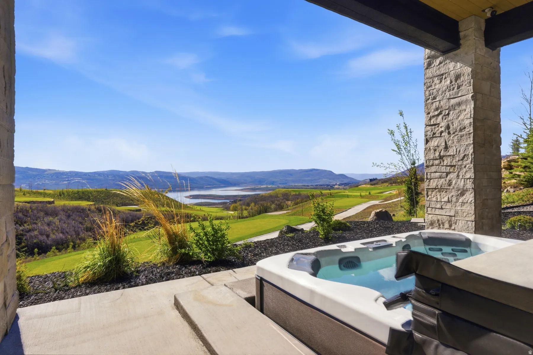 View of patio with a hot tub, a mountain view, and area for grilling