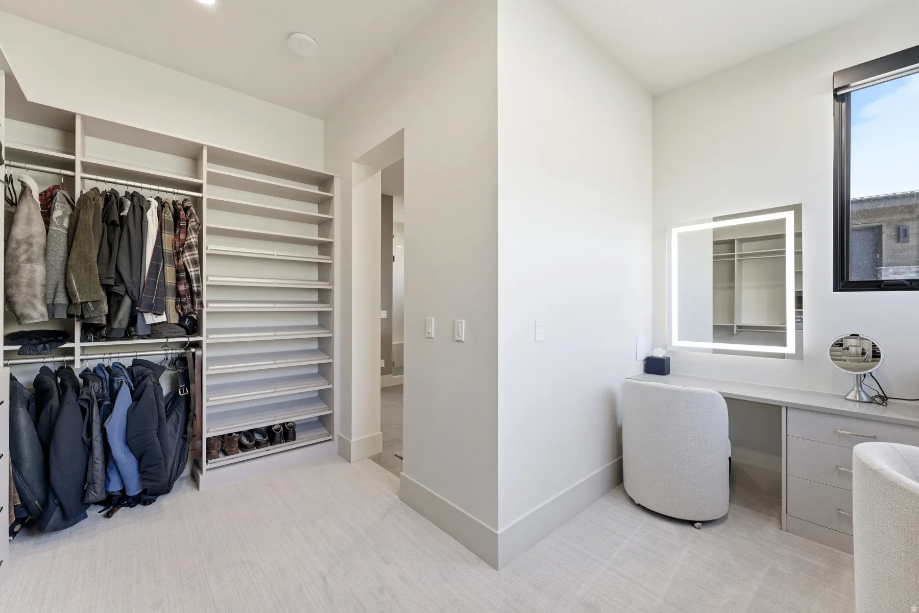 Full bath featuring a walk in closet, light colored carpet, and vanity