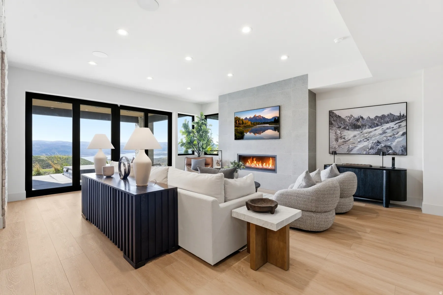 Living room featuring light wood-style floors, recessed lighting, and a tiled fireplace