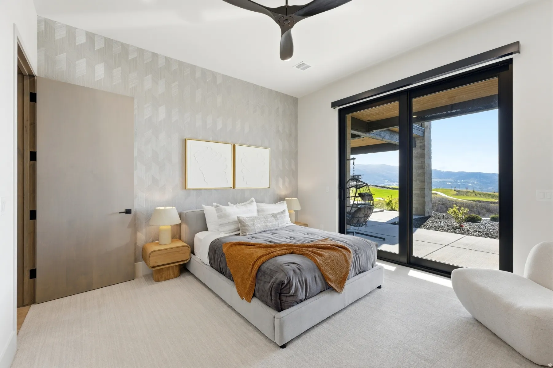 Bedroom featuring access to exterior, a ceiling fan, light colored carpet, and wallpapered walls