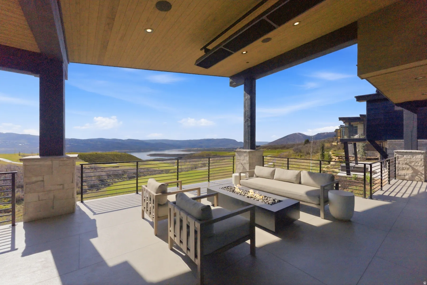 View of patio with a mountain view and an outdoor living space with a fire pit