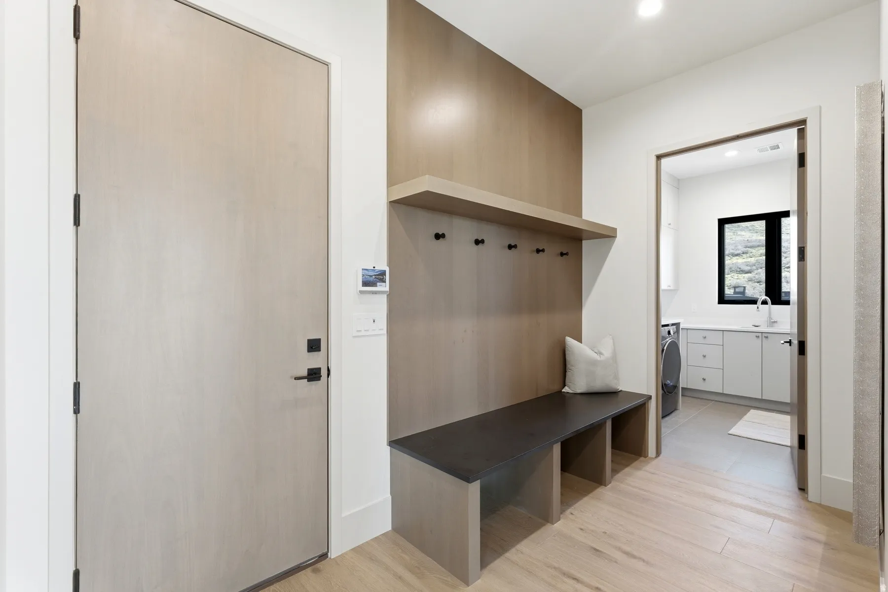 Mudroom featuring light wood-style flooring, recessed lighting, and washer / dryer