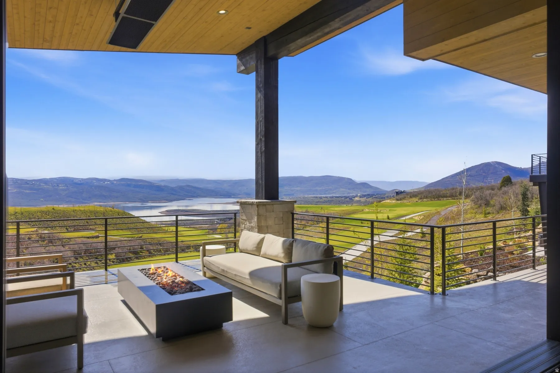 View of patio featuring a mountain view and an outdoor living space with a fire pit