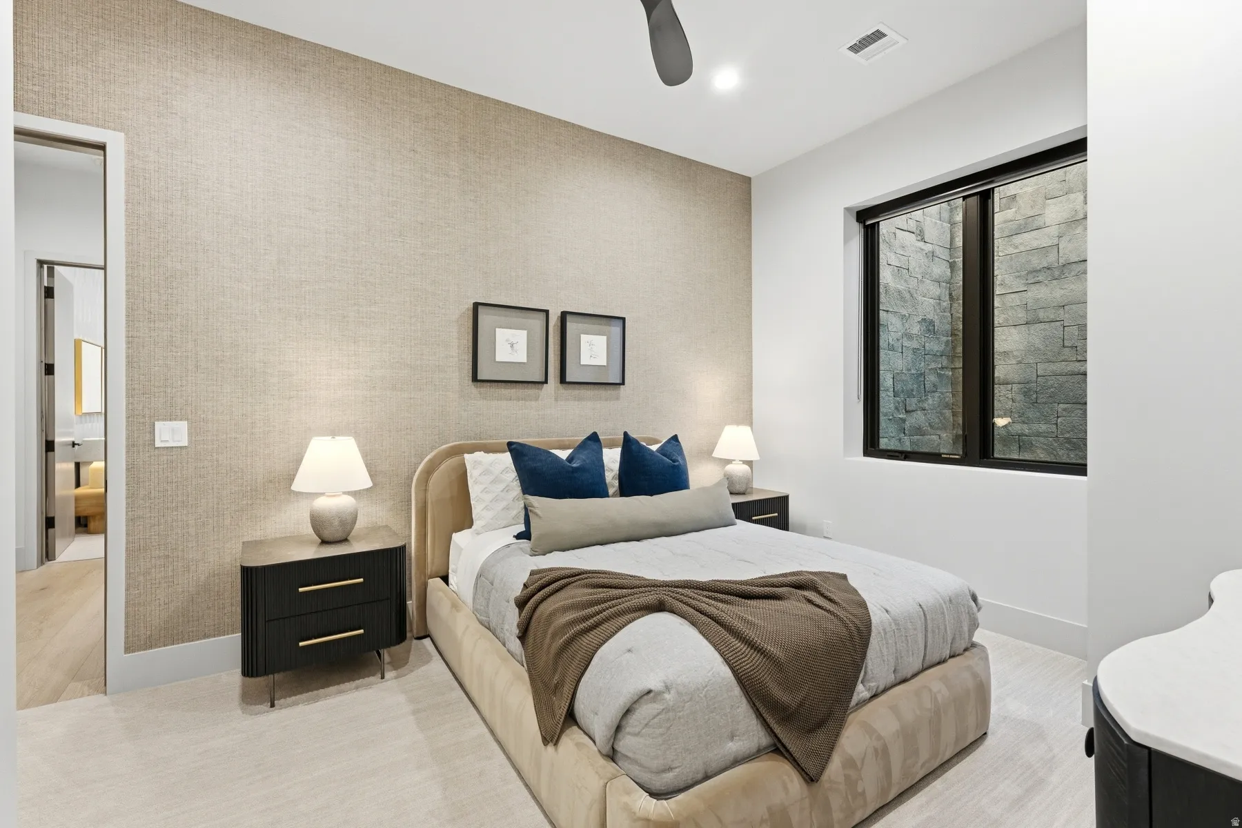 Bedroom with a ceiling fan, recessed lighting, and an accent wall