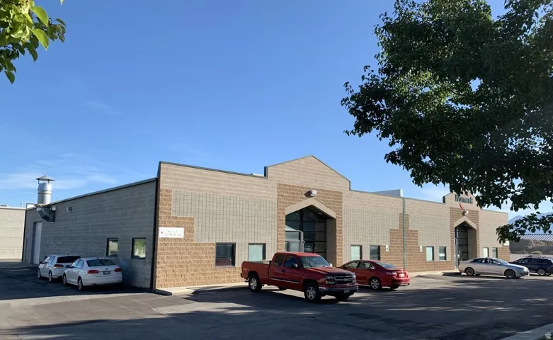 View of property featuring uncovered parking