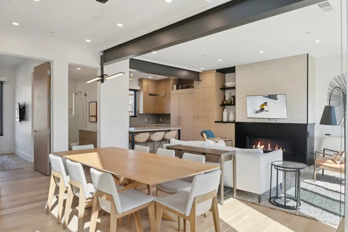 Dining area featuring light wood-type flooring, recessed lighting, and a large fireplace