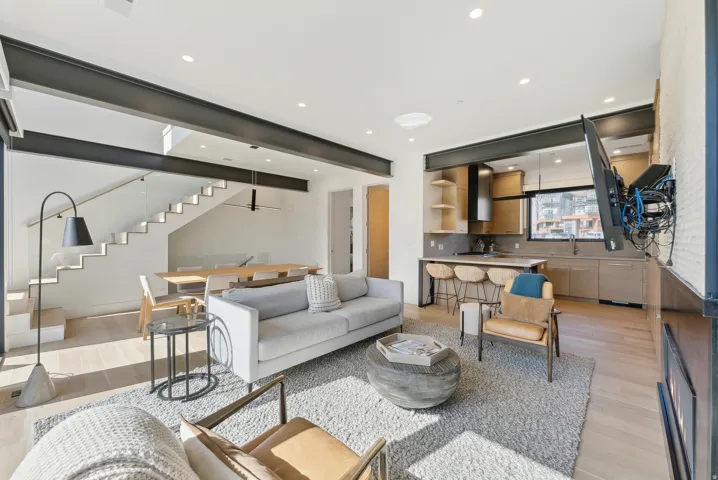 Living room with light wood finished floors and recessed lighting