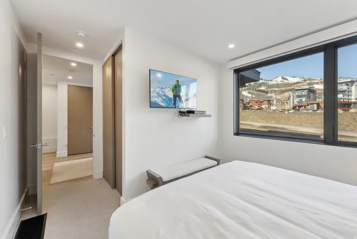 Bedroom with a closet, light colored carpet, and recessed lighting