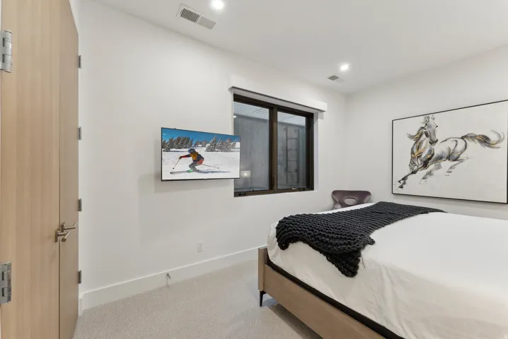 Bedroom featuring light carpet and recessed lighting