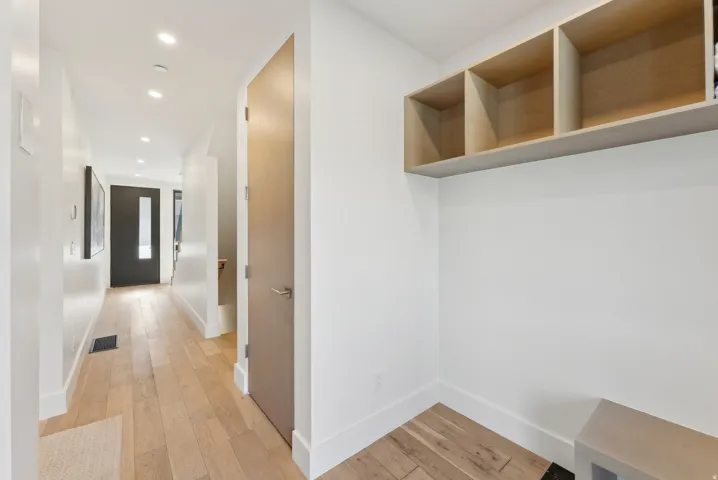 Mudroom with recessed lighting and light wood-style floors