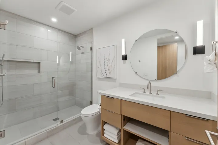 Full bath featuring vanity, a shower stall, light tile patterned floors, and recessed lighting