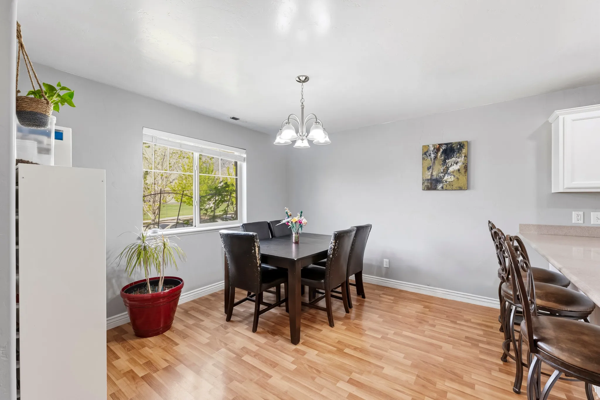 Dining room featuring light wood-style flooring and hanging lights