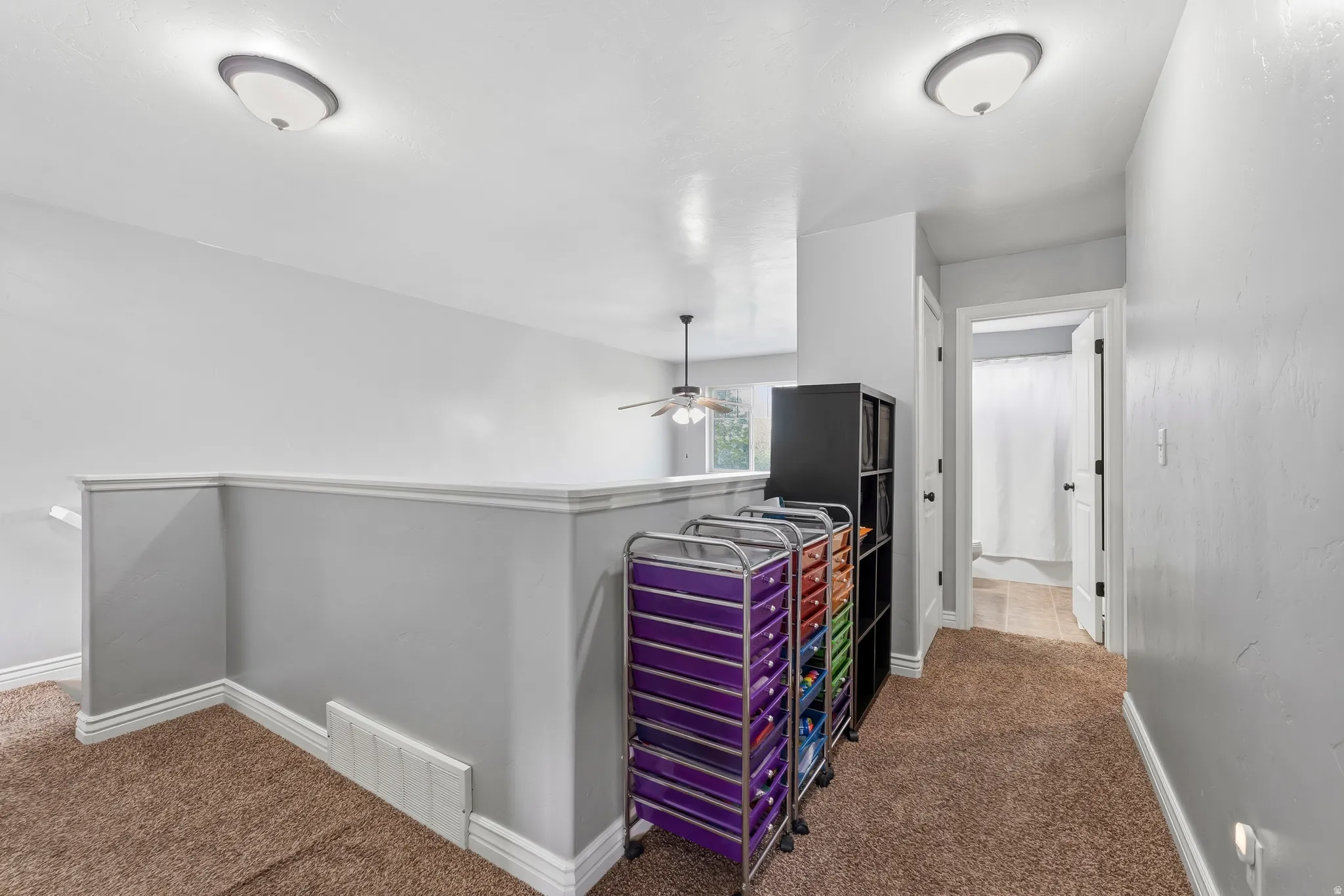 Hallway with dark colored carpet
