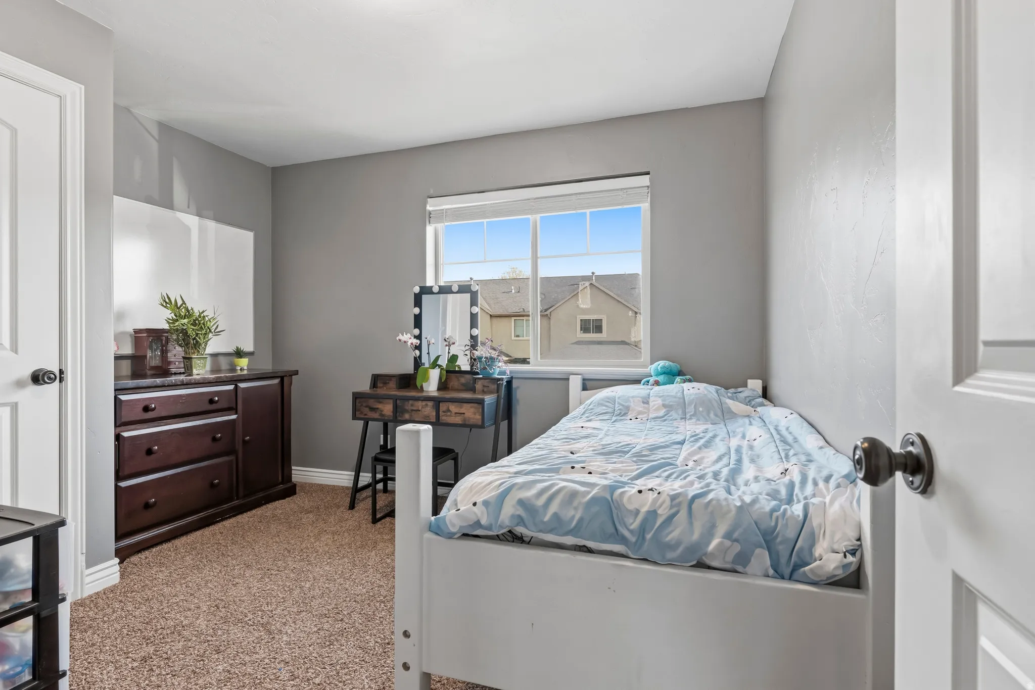 Bedroom featuring baseboards and light colored carpet