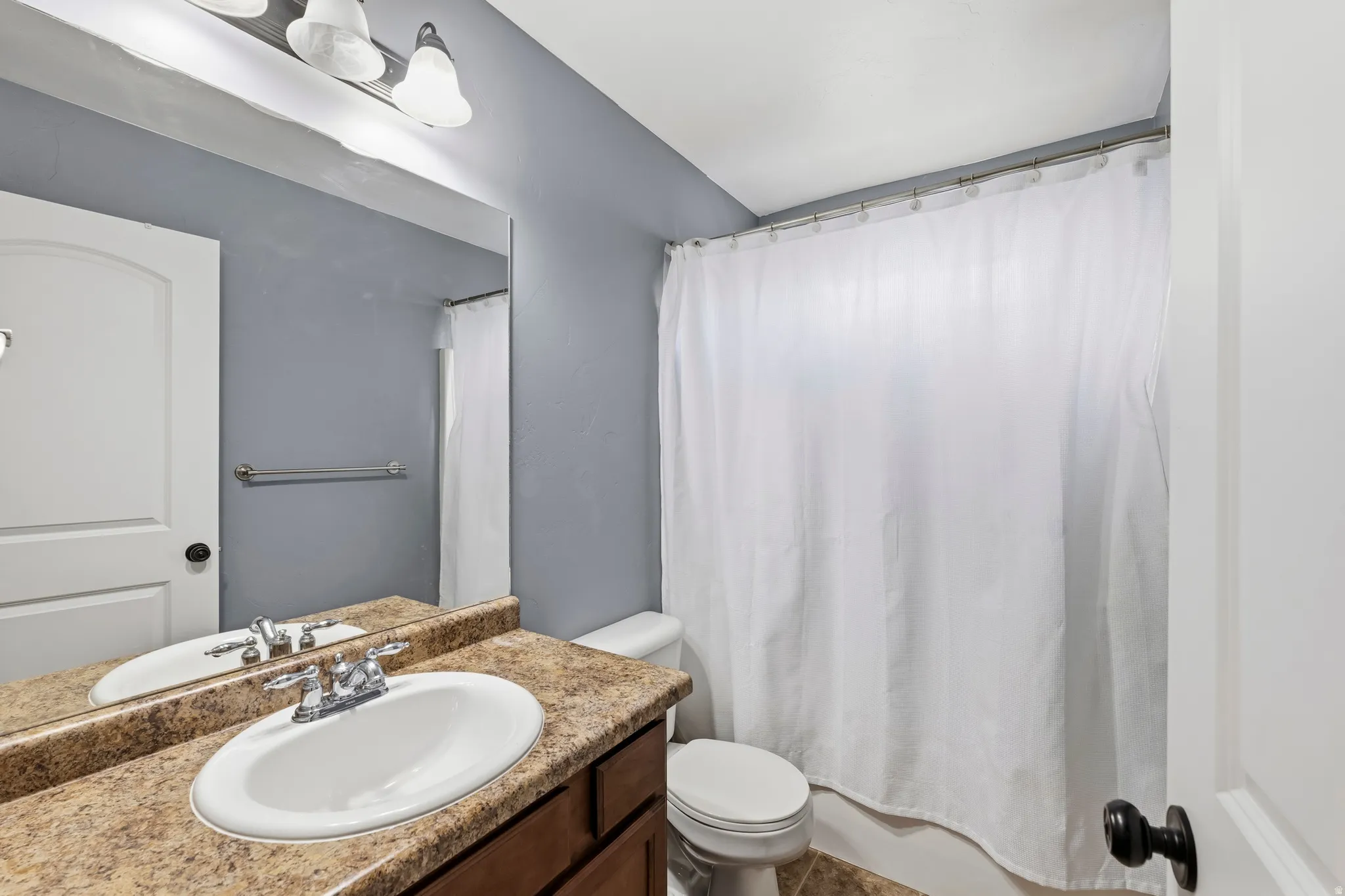 Full bathroom with vanity and shower / bath combination with curtain