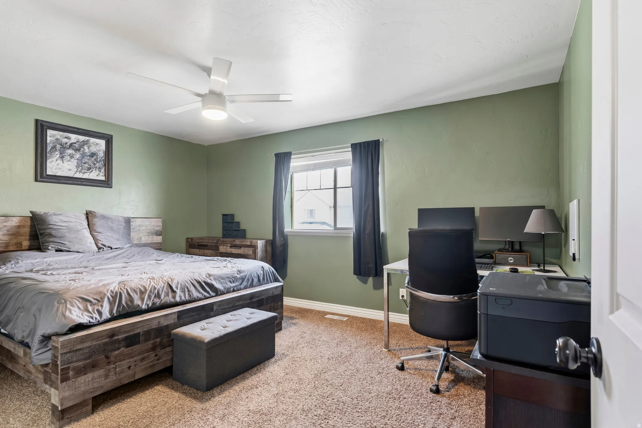 Bedroom featuring carpet floors, ceiling fan, and an office area