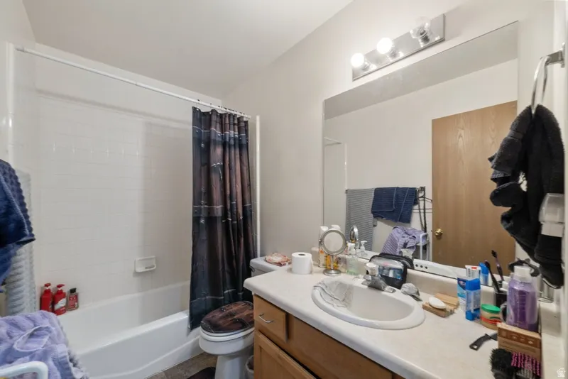 Bathroom featuring vanity and shower / tub combo with curtain