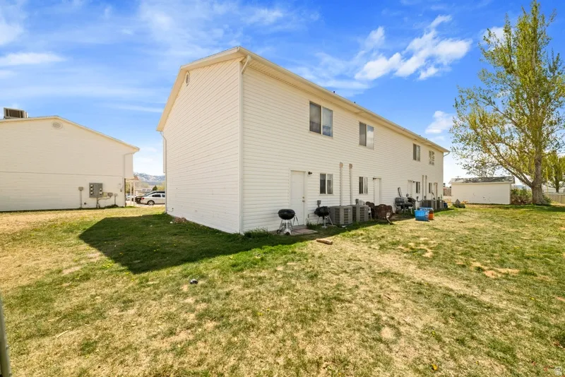 Rear view of house with a yard