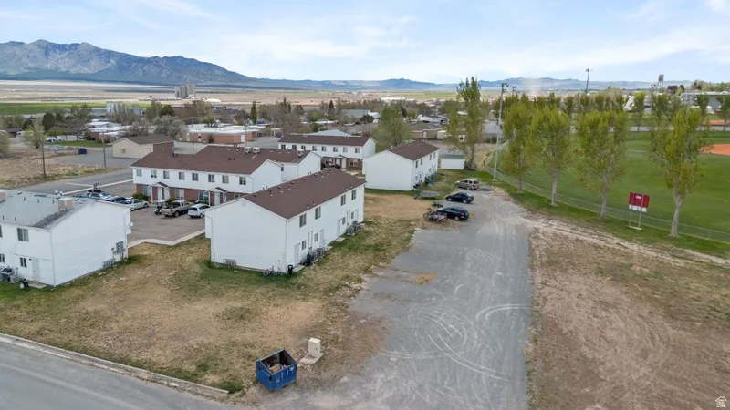 Aerial perspective of suburban area featuring a mountain backdrop