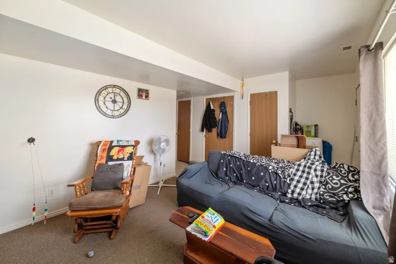 Living area featuring carpet and baseboards