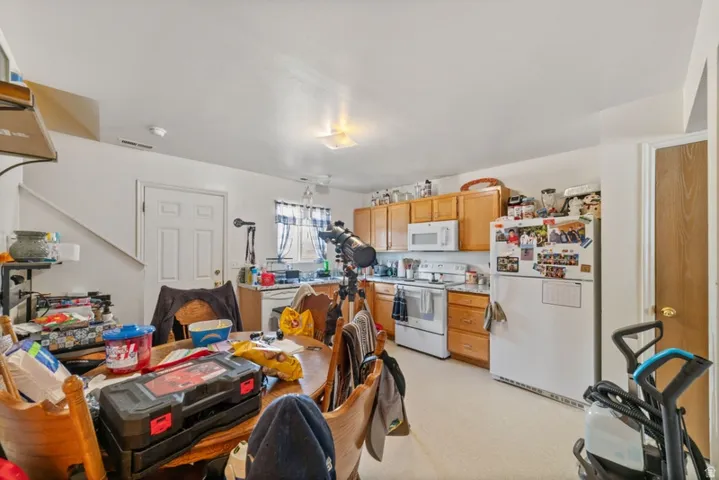 Kitchen featuring white appliances and light countertops