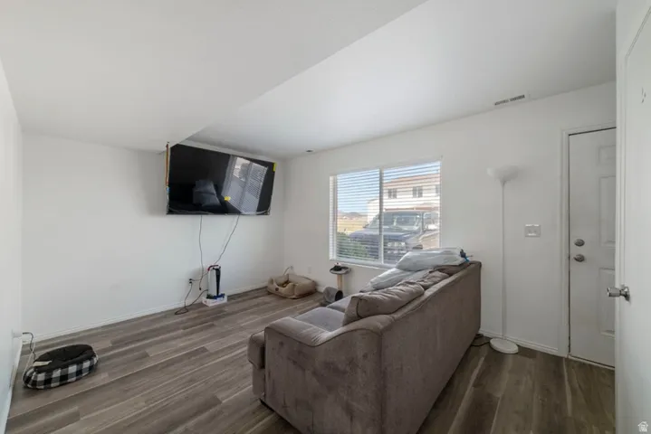 Living area with dark wood finished floors and baseboards