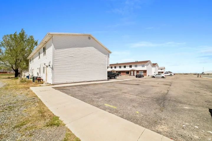 View of home's exterior with uncovered parking