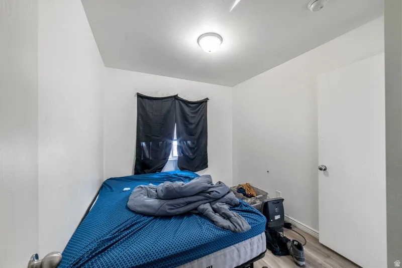 Bedroom featuring light wood-type flooring and baseboards