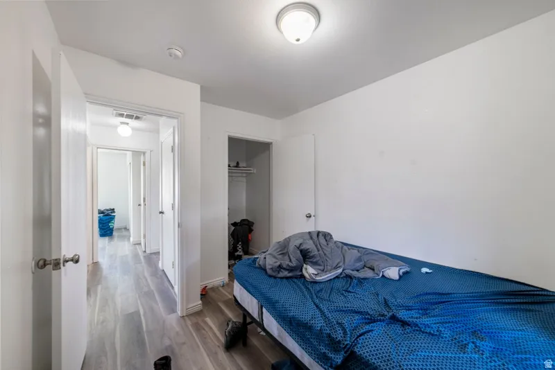 Bedroom with a closet and wood finished floors