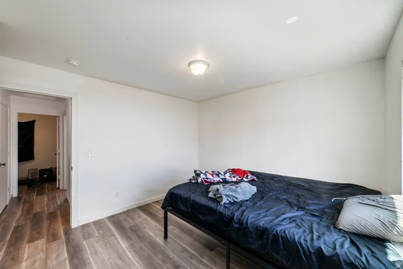 Bedroom featuring wood finished floors and baseboards