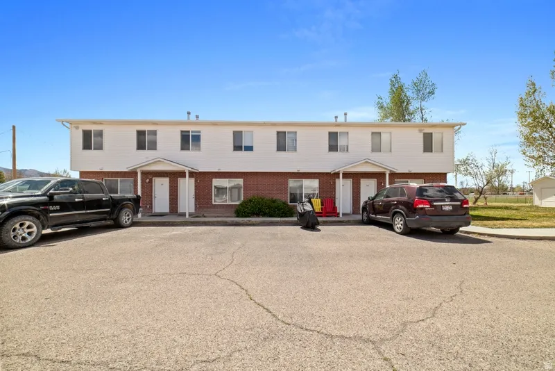 View of front of house featuring brick siding and uncovered parking