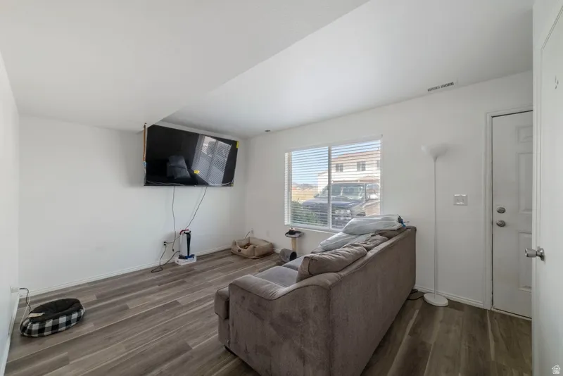Living area with dark wood finished floors and baseboards