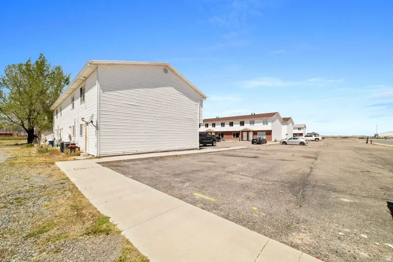 View of home's exterior with uncovered parking
