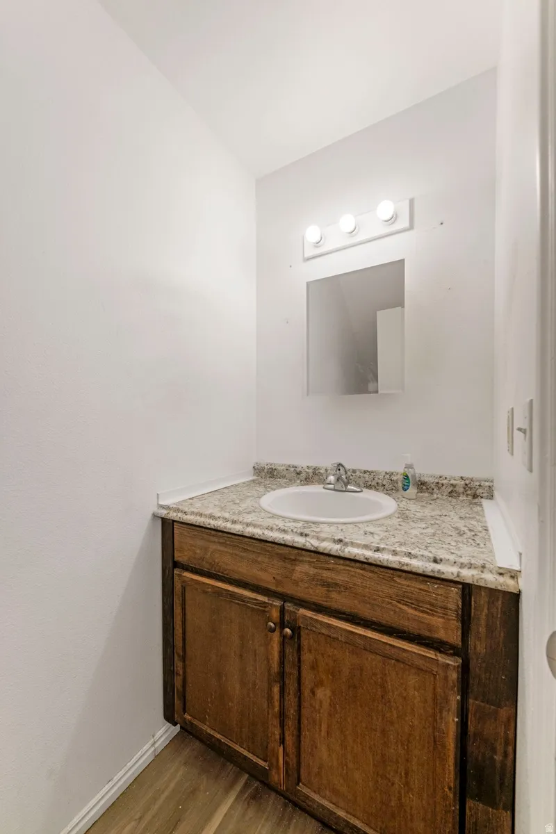 Bathroom featuring vanity and wood finished floors